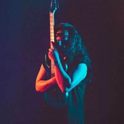 Dramatic neon-lit portrait of a guitarist — photo by Đức Trung Đào on Pexels