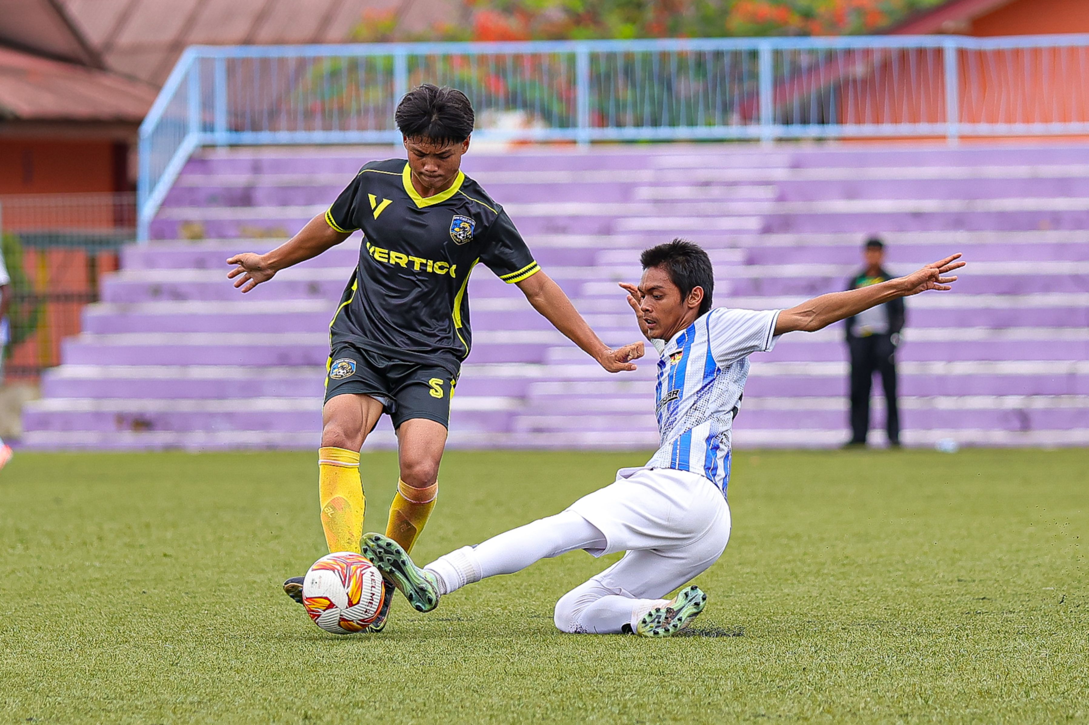 Intense Soccer Tackle on Green Field