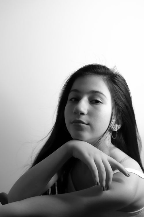 Free Black and white portrait capturing a serene young woman with a minimalist style. Stock Photo
