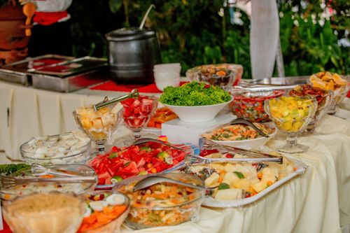 Free Colorful assorted dishes on an outdoor buffet table ready to serve at a gathering. Stock Photo