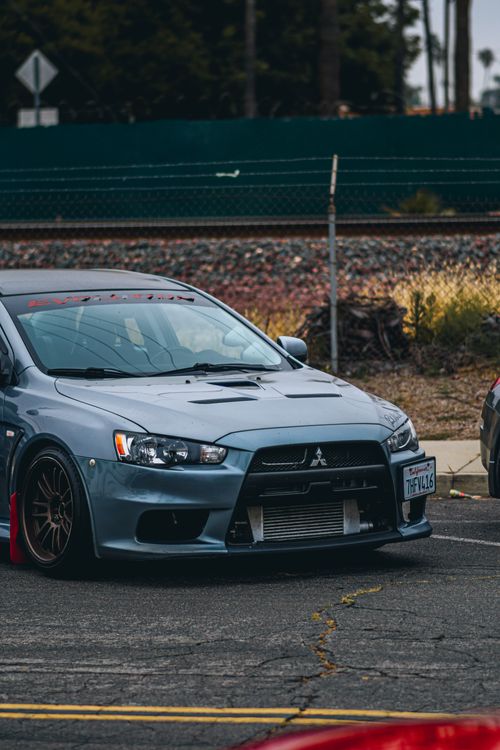 Free A sleek Mitsubishi Evo parked at a car meet, showcasing its stylish design. Stock Photo