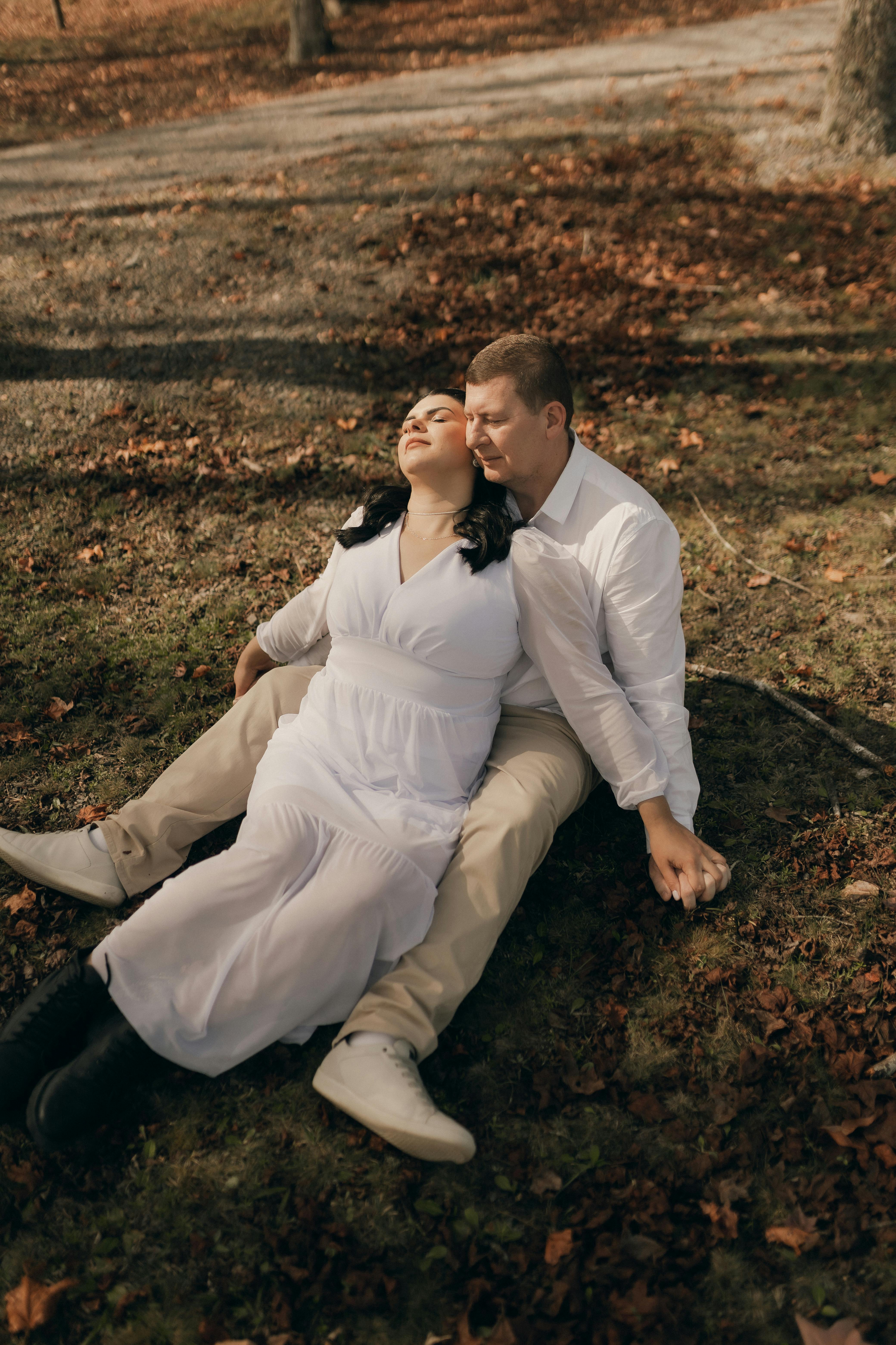 Romantic couple in tender embrace on an autumn day, soft light highlighting intimate connection and calm surrender