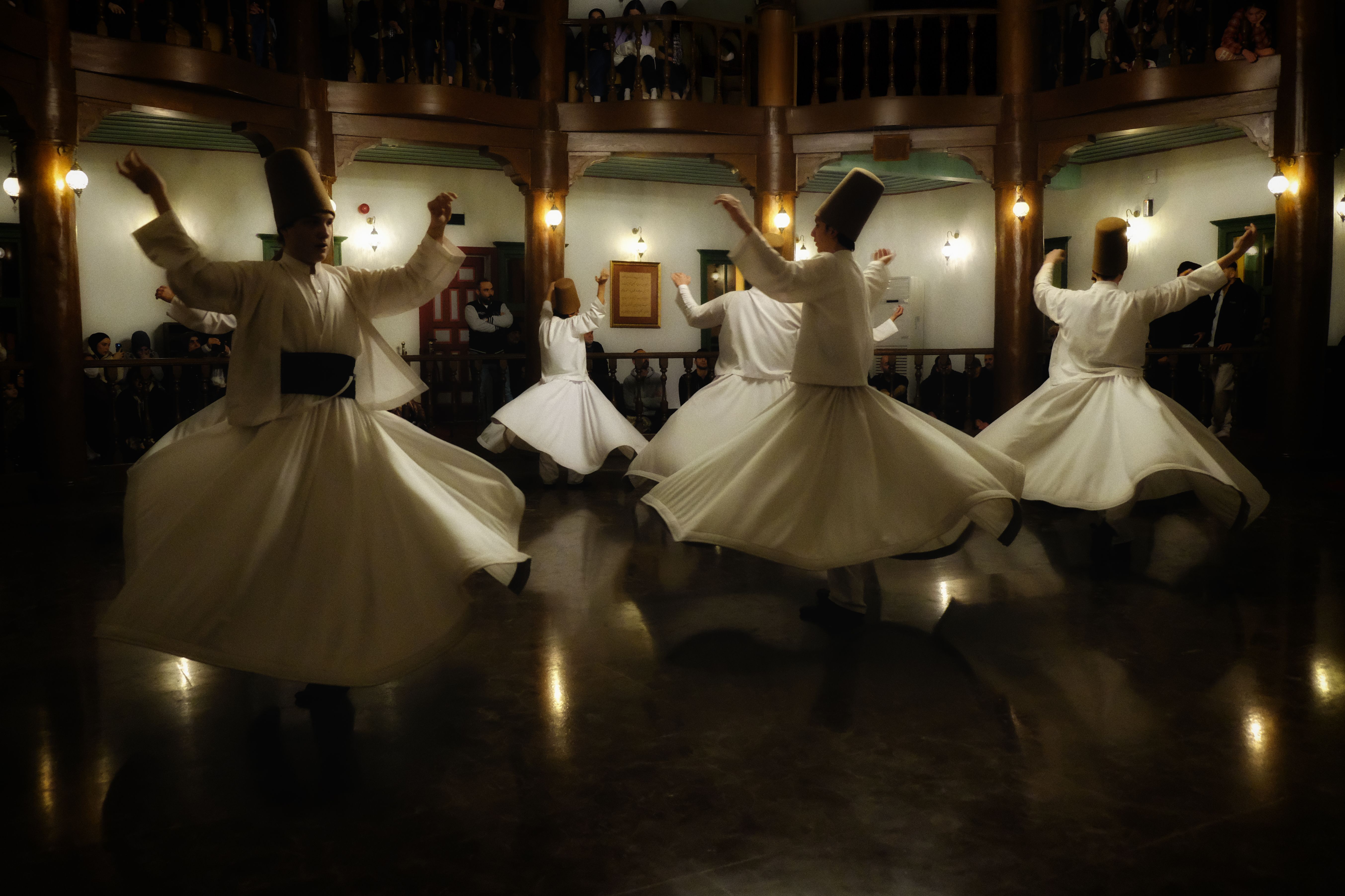 Whirling dervishes in traditional attire perform the sacred Mevlevi Sema ceremony in Bursa, Türkiye.