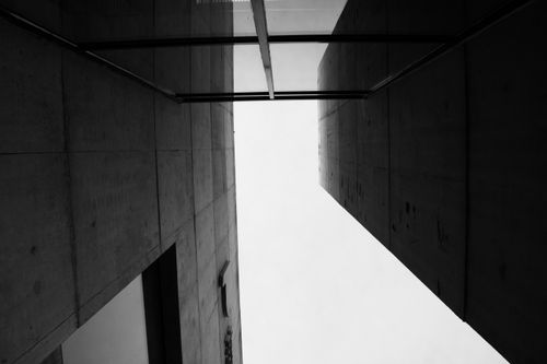 Free A dramatic black and white perspective of modern architectural structures. Stock Photo