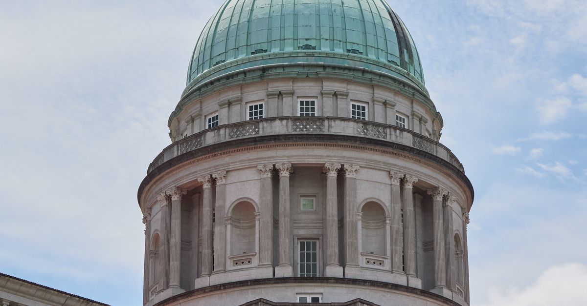 National Gallery Singapore dome against a bright blue sky.
