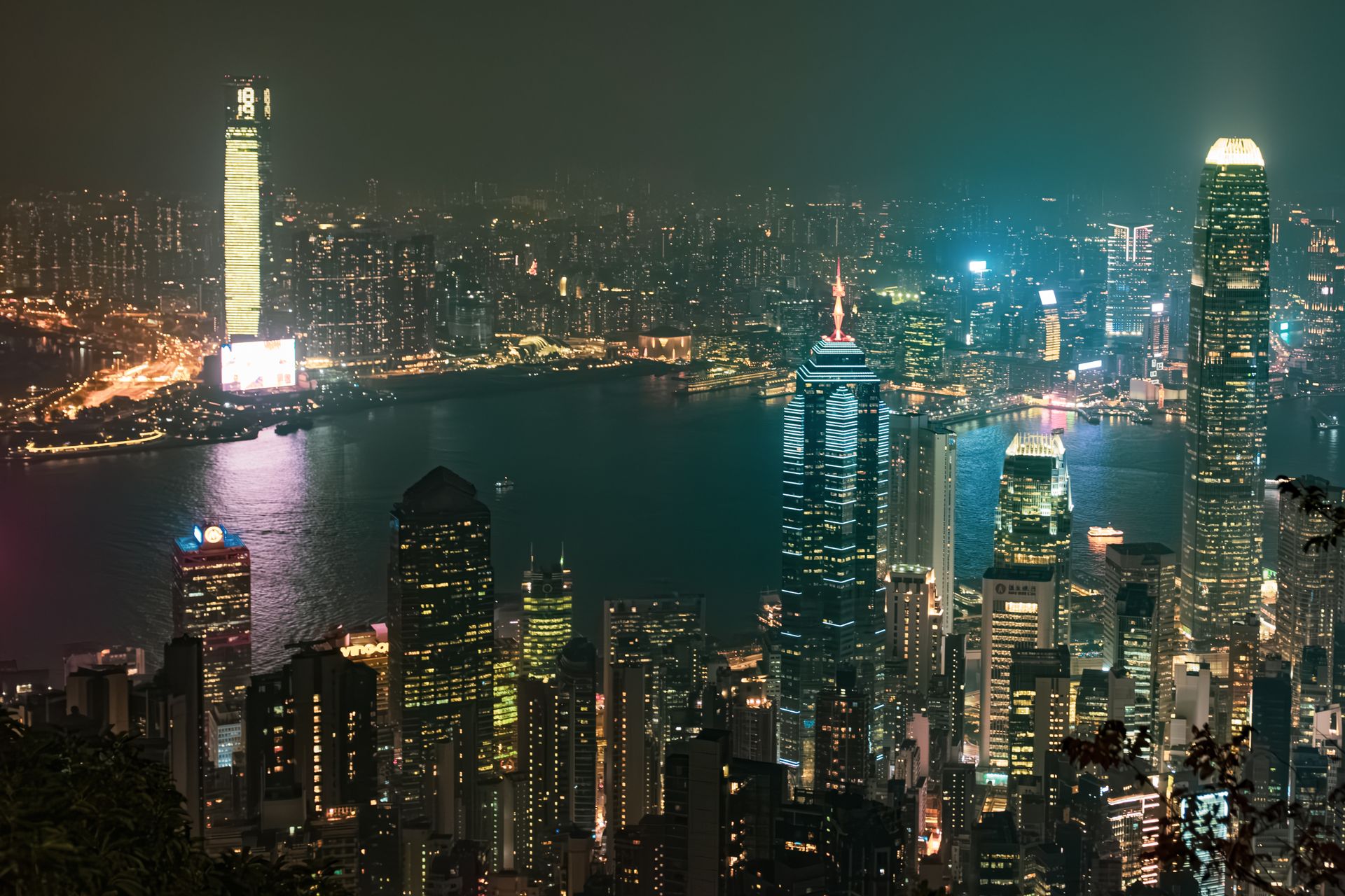 A mesmerizing night view of Hong Kong skyline with illuminated skyscrapers and waterfront.