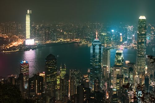 Free A mesmerizing night view of Hong Kong skyline with illuminated skyscrapers and waterfront. Stock Photo