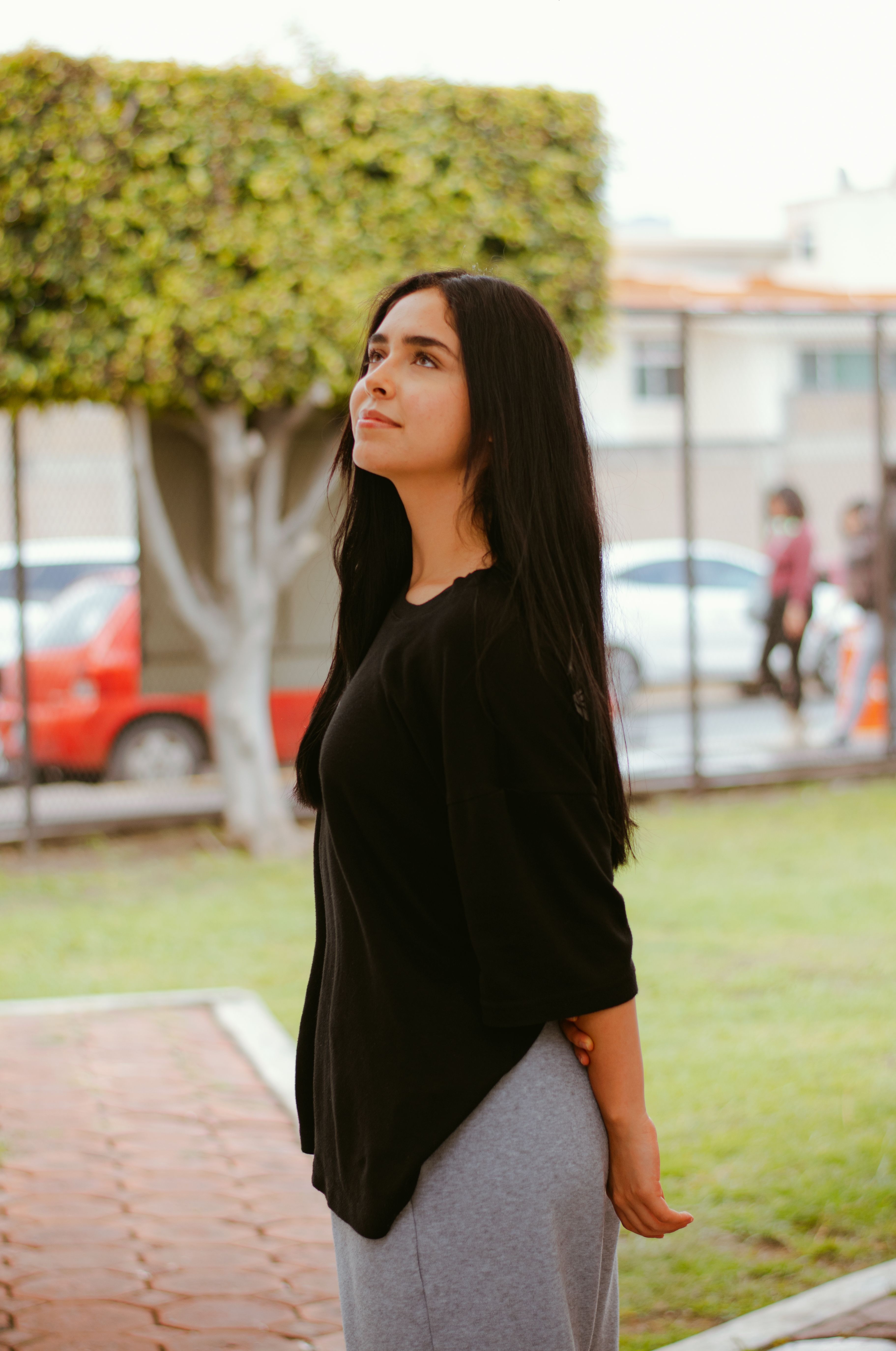 Contemplative Woman in Outdoor Urban Setting · Free Stock Photo