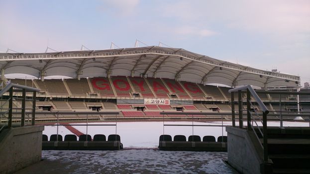 Scenic view of Goyang Stadium in winter, with snow covering the seats and field.