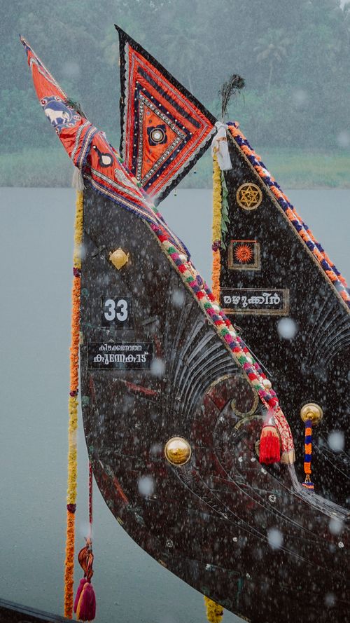 Free Colorful snake boats adorned with ornaments on a rainy river in Kerala, India. Stock Photo