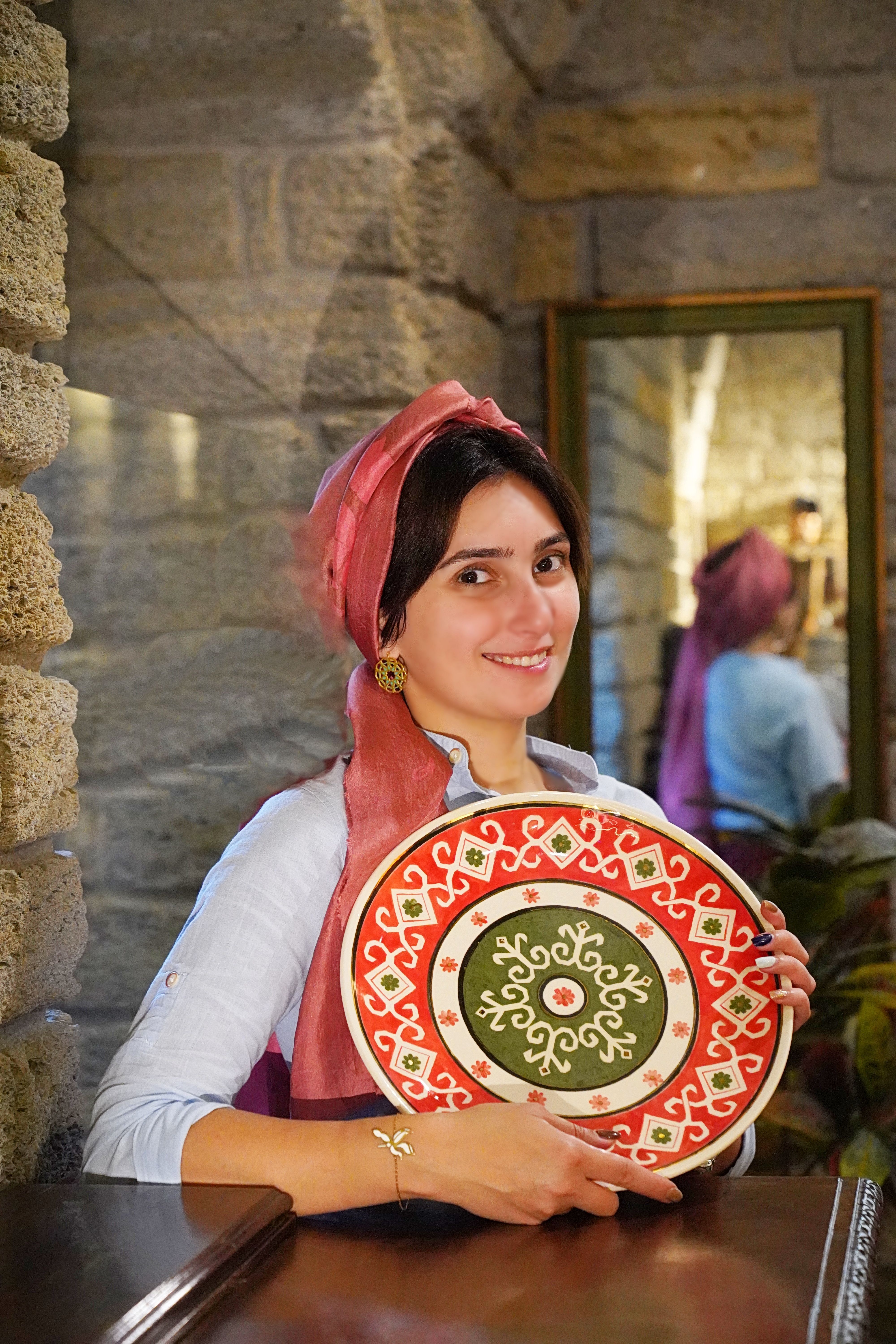 Smiling Woman Holding Decorative Plate Indoors