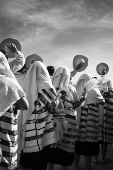 Black and white photo of a traditional dance in Oaxaca, featuring cultural attire and sombreros.