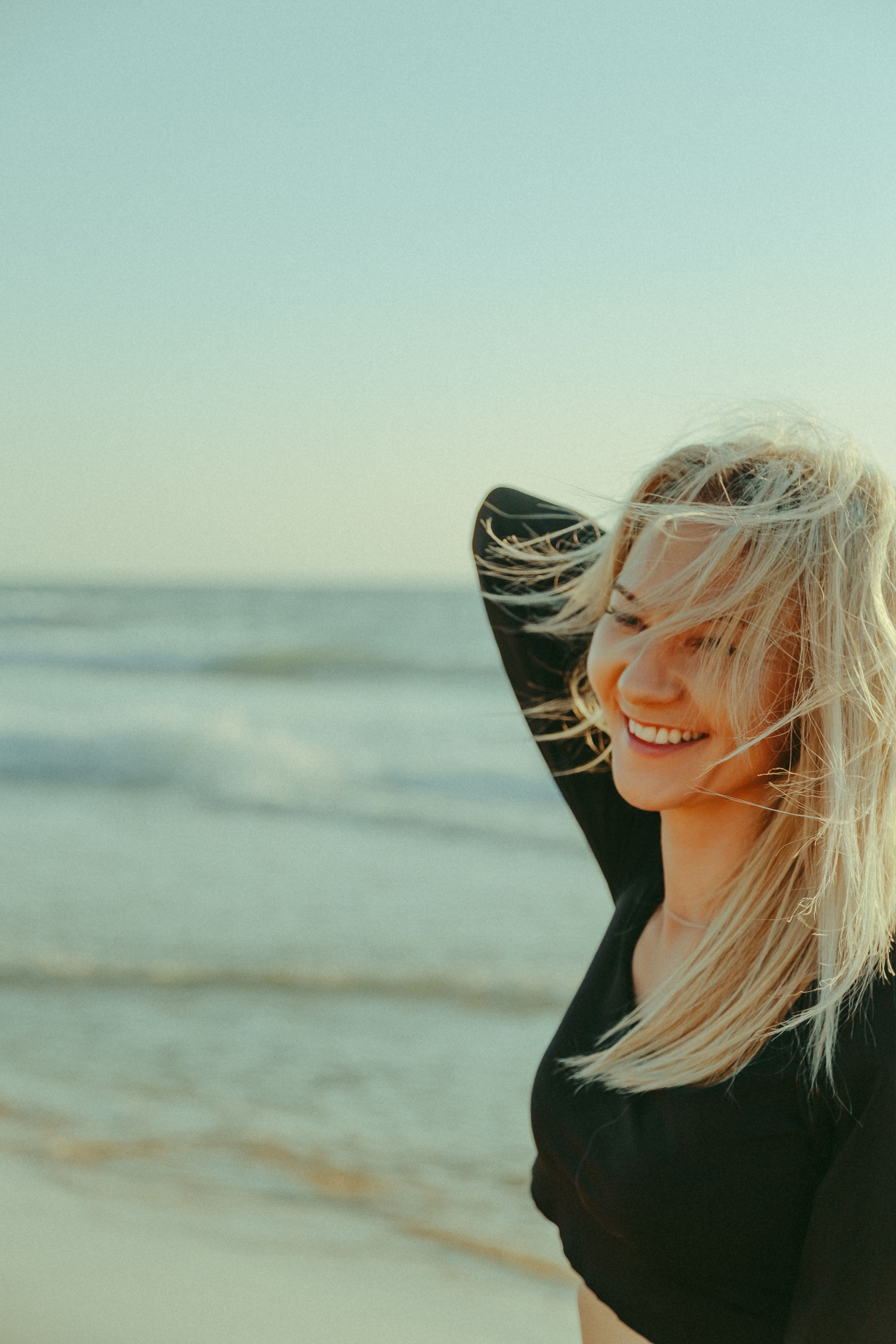 Happy Woman Posing on a Sunny Beach · Free Stock Photo