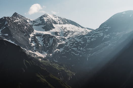 Stunning view of snow-covered peaks under dramatic light in the Austrian Alps.
