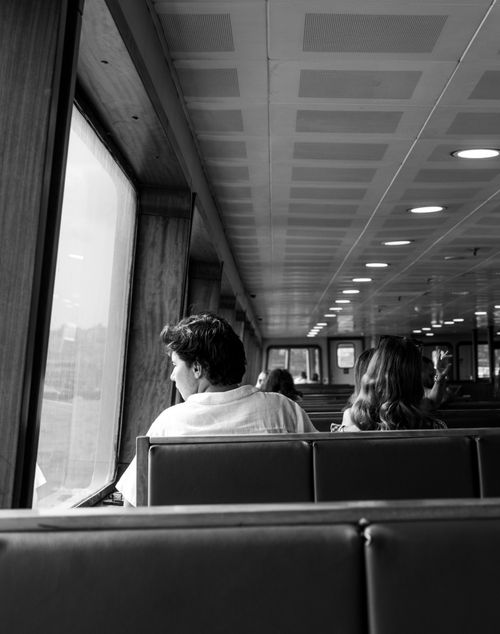 Free A monochrome capture of passengers inside an Istanbul ferry, highlighting a serene travel moment. Stock Photo