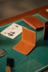Hand-stitched leather wallet, photo by Gül Işık on Pexels
