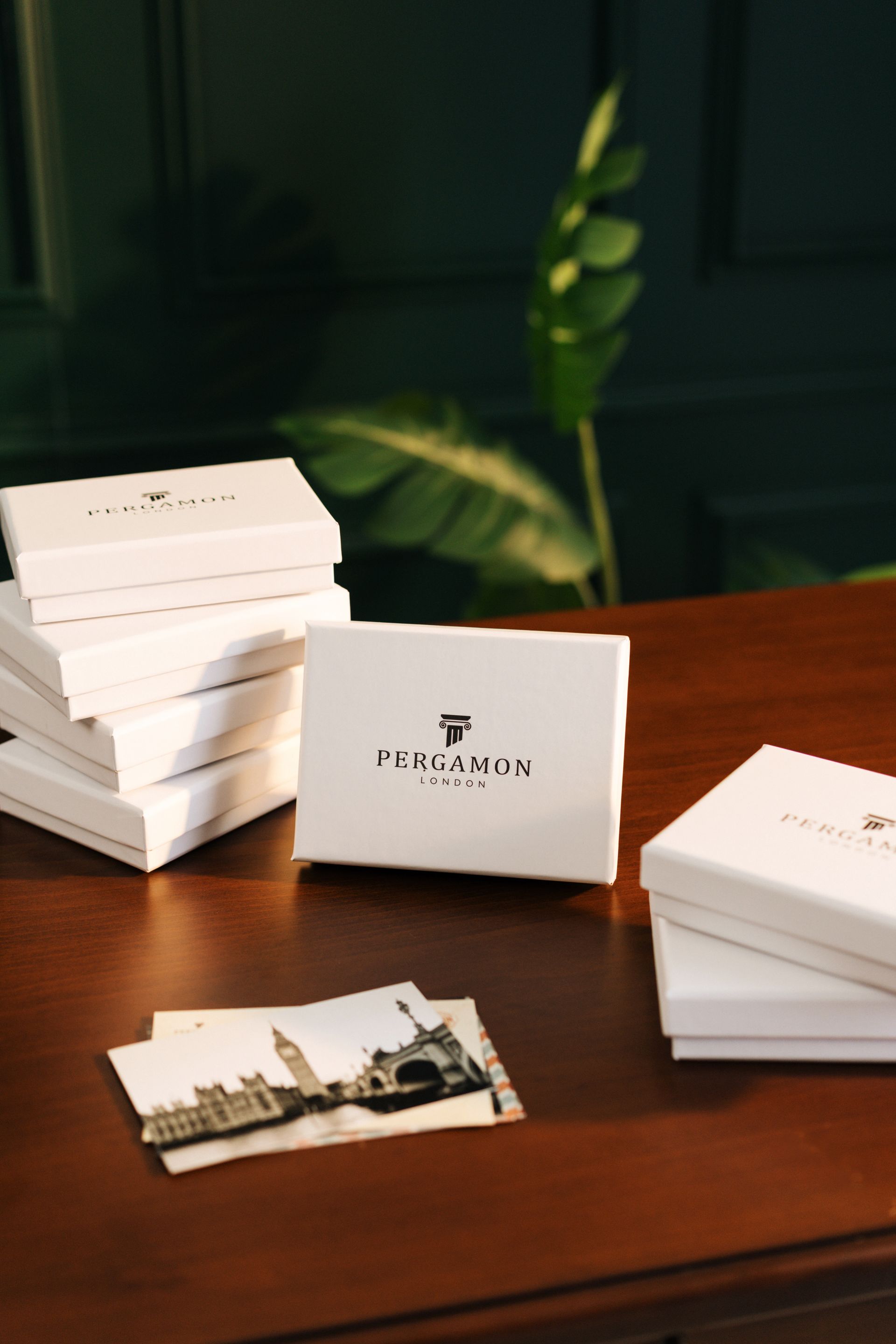 Stylish branded gift boxes arranged on a wooden table