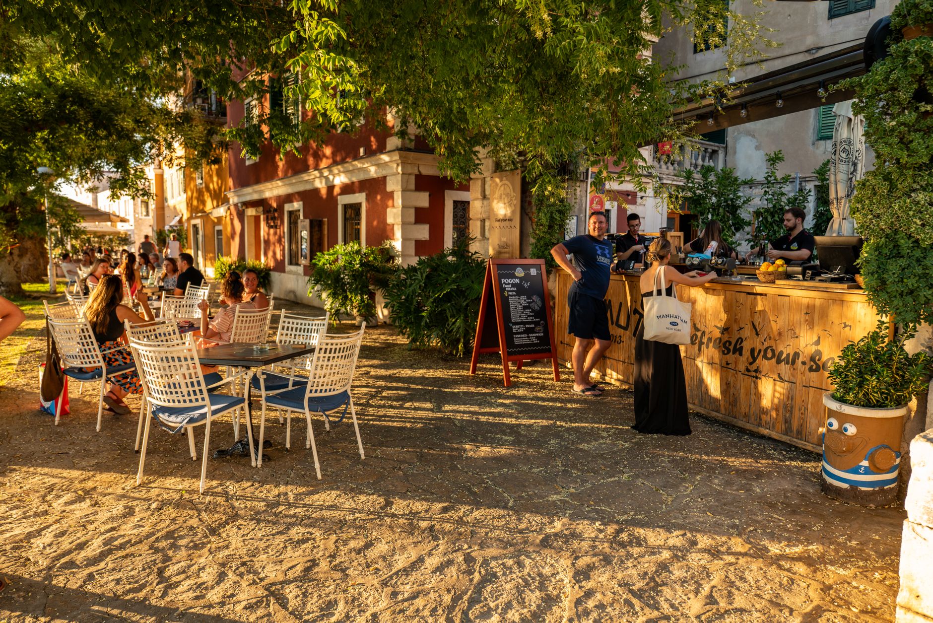 People enjoying a warm summer evening at an outdoor café in Šibenik, Croatia.