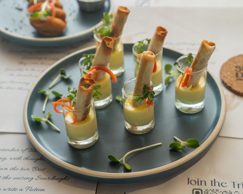 Free Elegant appetizer platter with spring rolls in glasses, ideal for stylish catering. Stock Photo