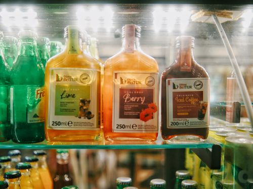 Free Vibrant assortment of bottled drinks in a well-lit refrigerator display. Stock Photo