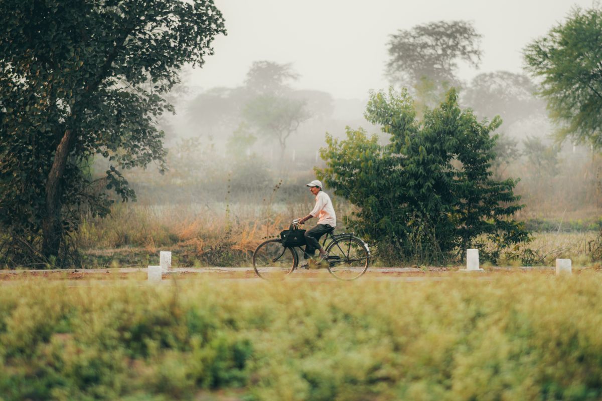 Cycliste sur une petite route de campagne irlandaise dans la brume, comté de Kerry
