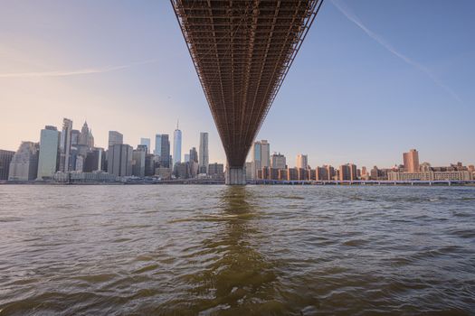 Captivating view of the Brooklyn Bridge with Manhattan skyline during sunset.
