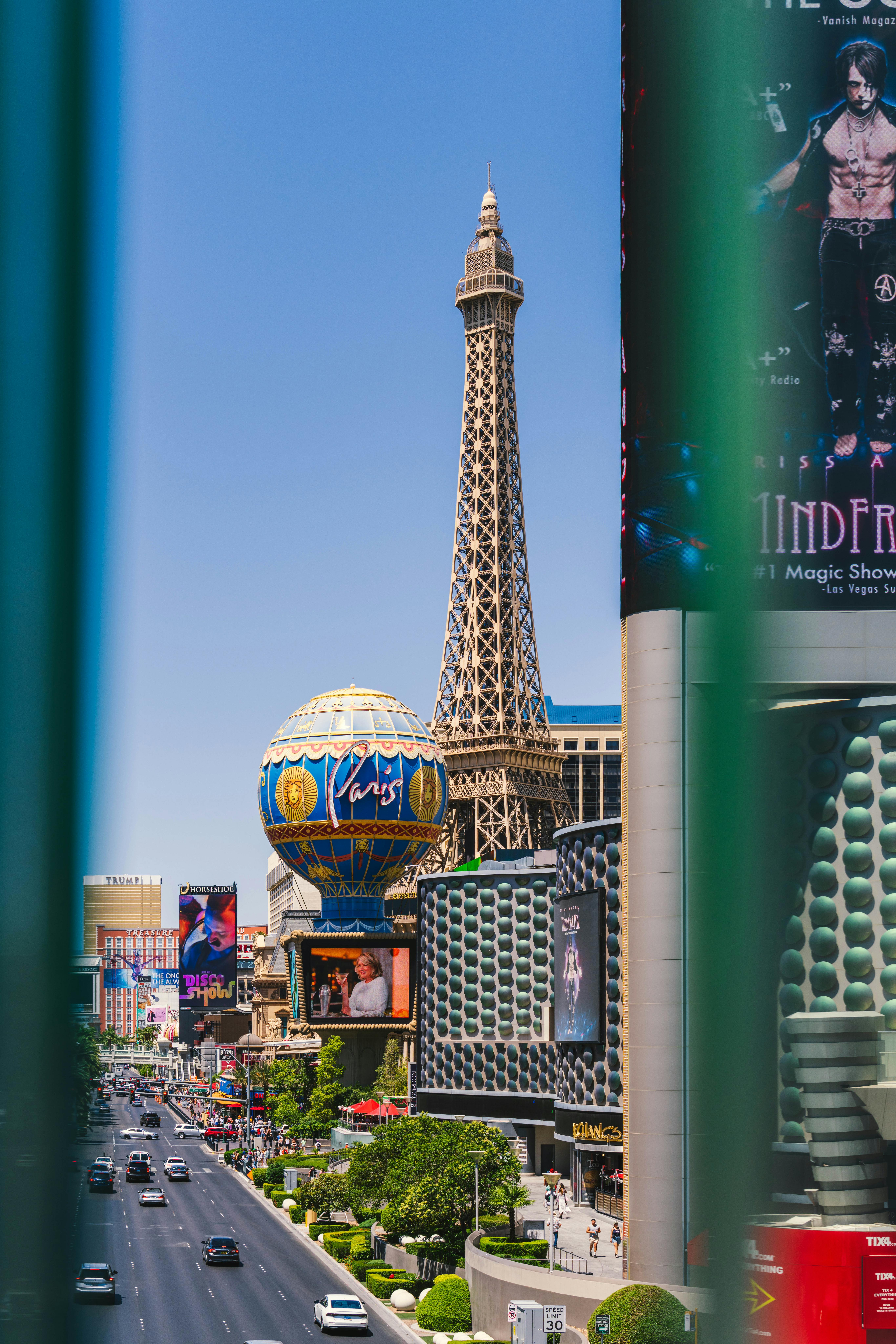 Bright day view of Eiffel Tower replica at Paris Las Vegas on the bustling Strip.