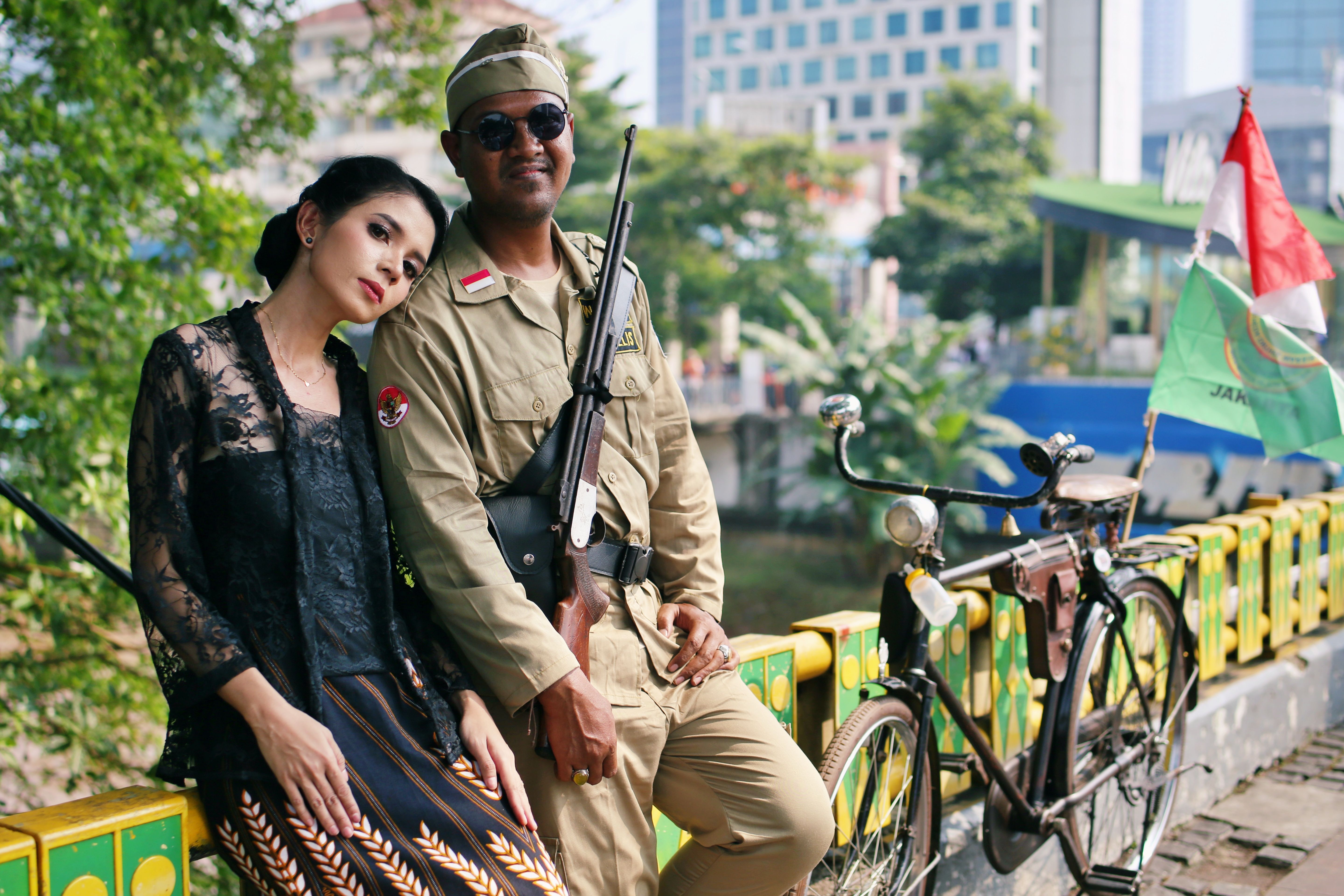 Vintage Military Couple with Bicycle in Urban Setting