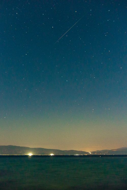 Free Capture the mesmerizing sight of a meteor shower over Ohrid Lake, North Macedonia. Stock Photo