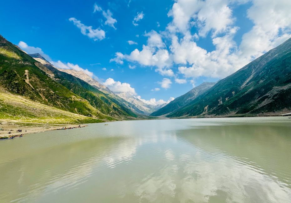 Breathtaking view of a serene lake surrounded by majestic mountains in Naran, Pakistan.