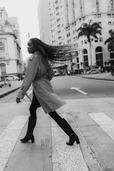 A fashionable woman gracefully walks across a crosswalk in Rio de Janeiro, Brazil.
