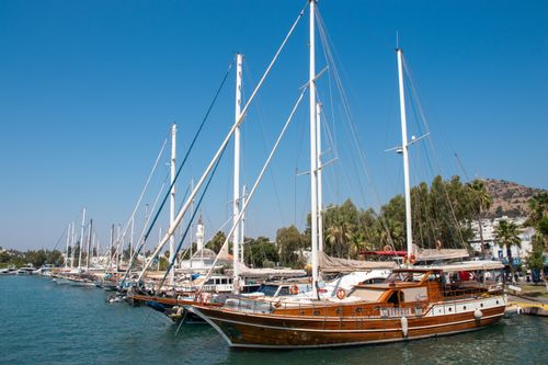 Free Beautiful sailboats moored at Bodrum harbor under a clear blue sky in Muğla, Turkey. Stock Photo