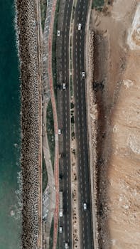 Stunning aerial view of a coastal highway in Arica, Chile with ocean and landscape contrast.