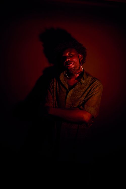 Free Portrait of an adult man with artistic red lighting and shadow contrast. Stock Photo