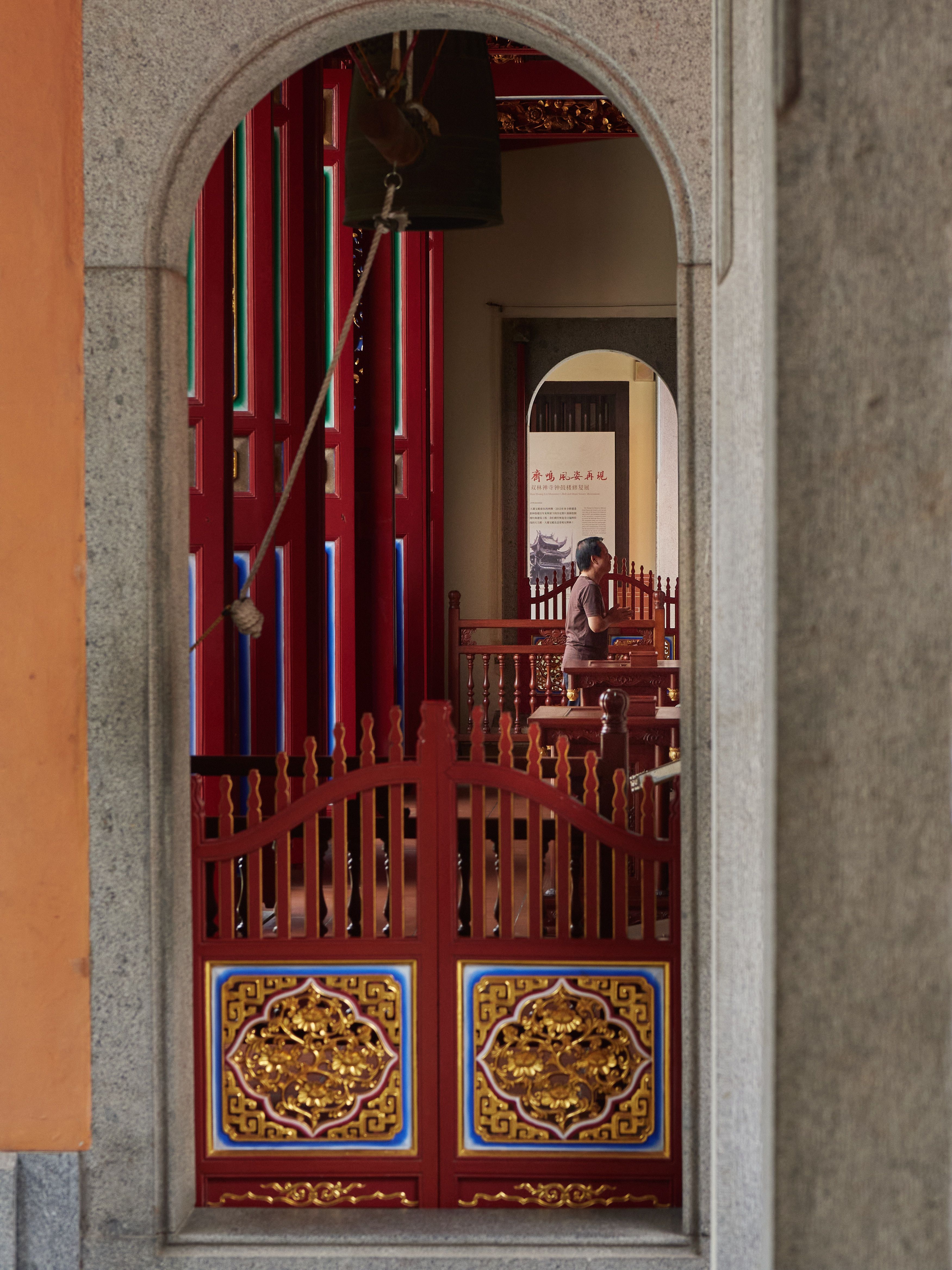 A vibrant view of a temple interior showcasing traditional architecture and ornate decor.