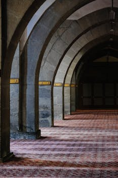 Explore the timeless elegance of stone arches in this historic building's interior corridor.
