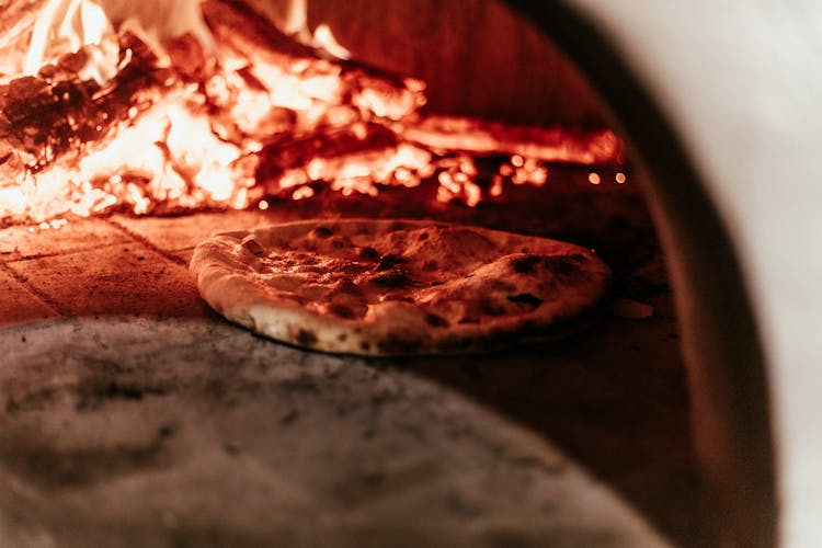 Selective Focus Photo Of Pizza In Furnace