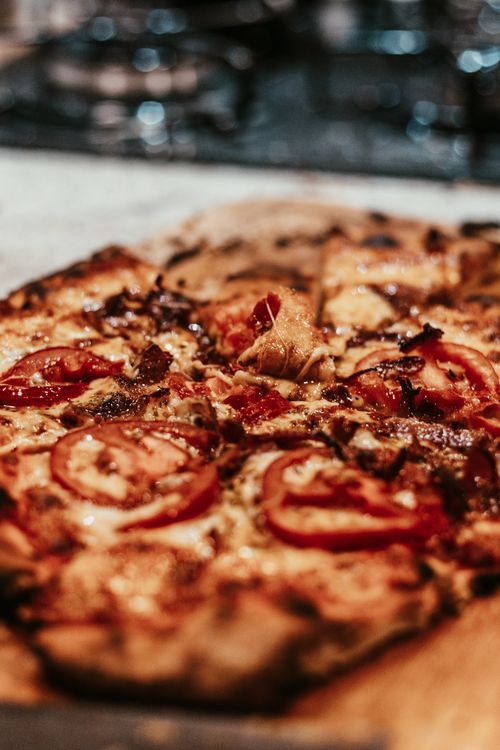 Free Delicious close-up of a freshly baked, mouthwatering Italian pizza with toppings. Stock Photo