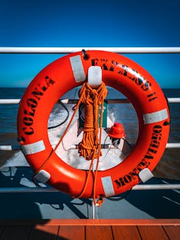 Bright orange lifebuoy on Colonia Express ferry, showcasing safety at sea in Uruguayan waters.