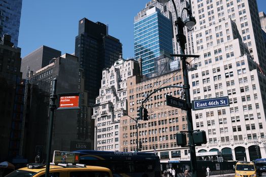 Bustling street scene at Fifth Avenue and East 46th Street in New York City.
