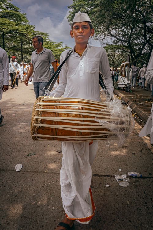 Free A young man plays a traditional drum in a vibrant Pune street parade, Maharashtra, India. Stock Photo