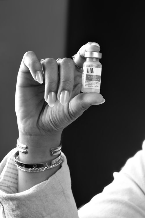 Free Black and white image of a hand holding a Sculptra vial, showcasing beauty treatment in Belo Horizonte, Brazil. Stock Photo