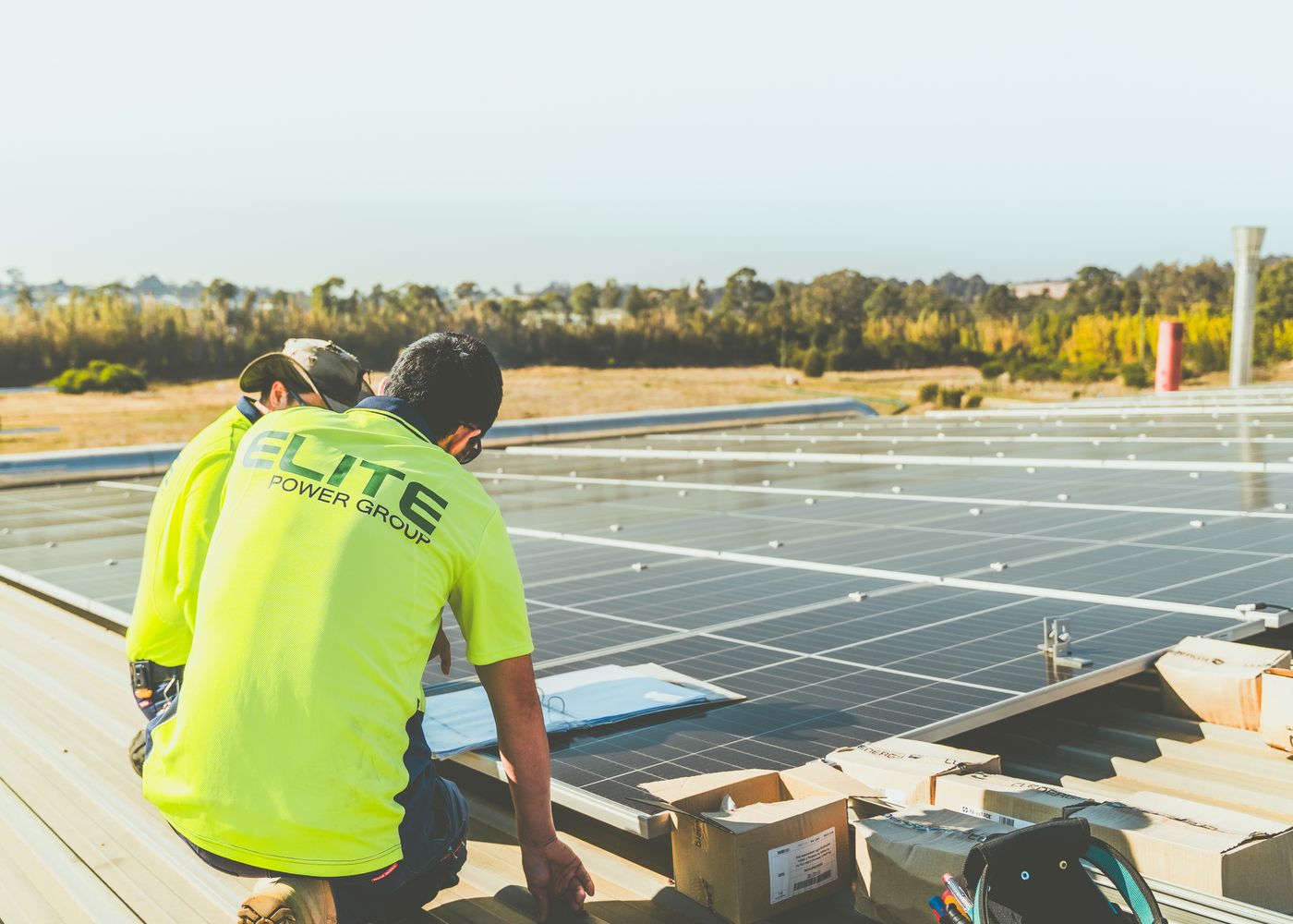 Technicians installing rooftop solar panels on a building in Hyderabad