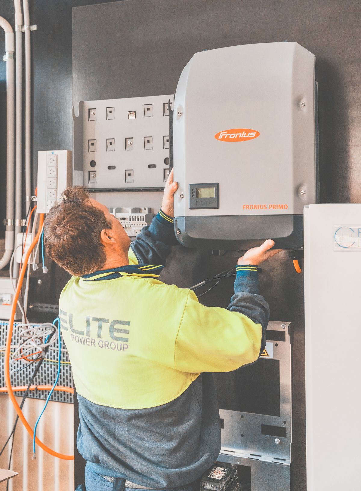 Expert technician setting up a solar inverter in Thornton, NSW, ensuring efficient solar energy flow.
