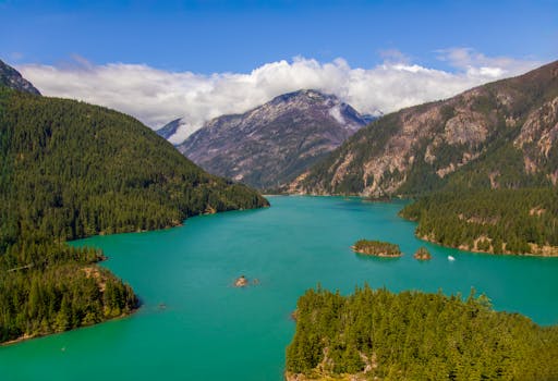 Beautiful aerial view of turquoise Diablo Lake surrounded by lush forests in Newhalem, Washington.