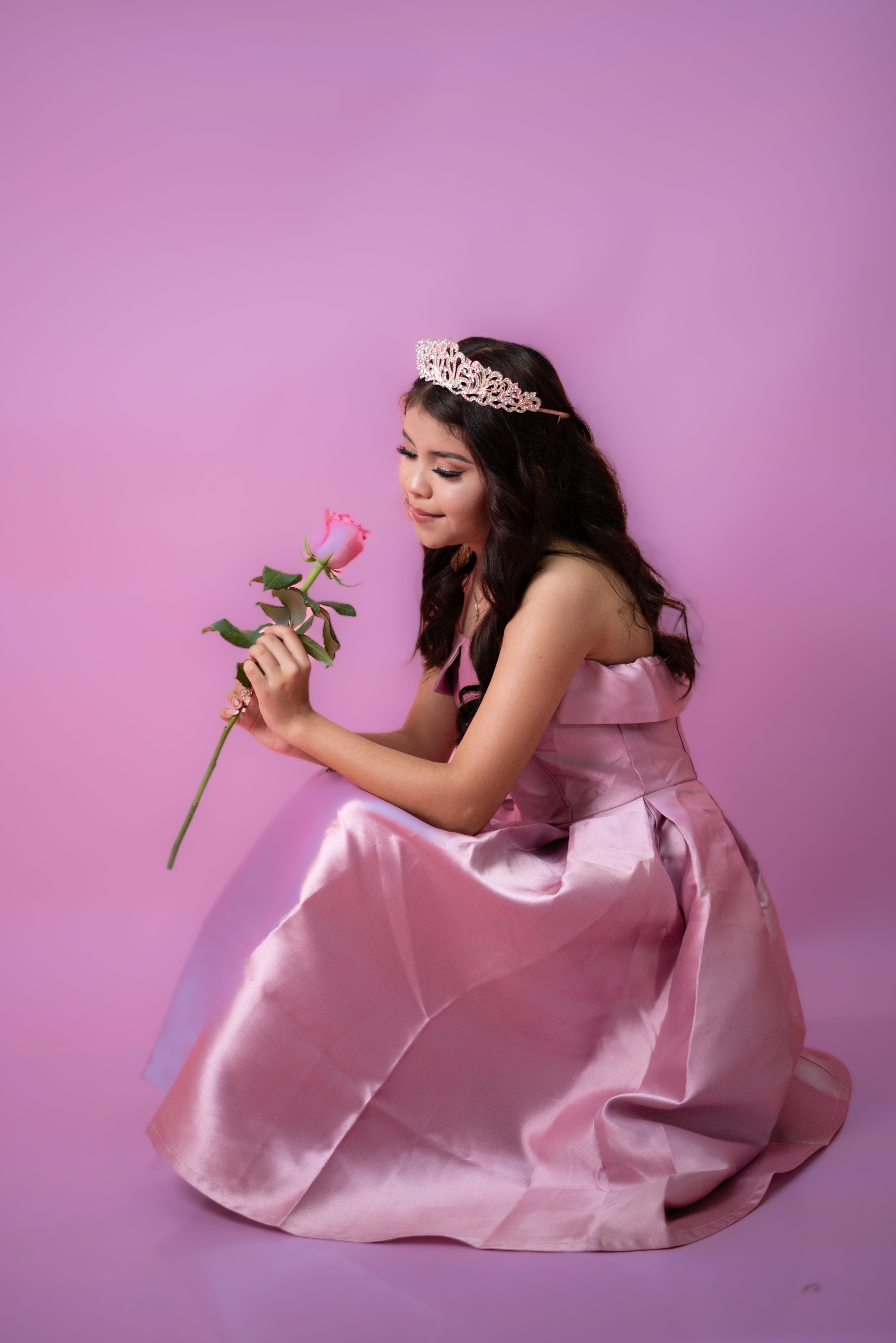 Elegant Young Woman in Pink Gown with Rose  Free Stock Photo