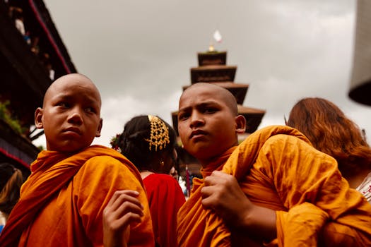 Nepali Buddhist monks in saffron robes participate in a vibrant cultural festival, capturing the essence of Nepal's traditions.