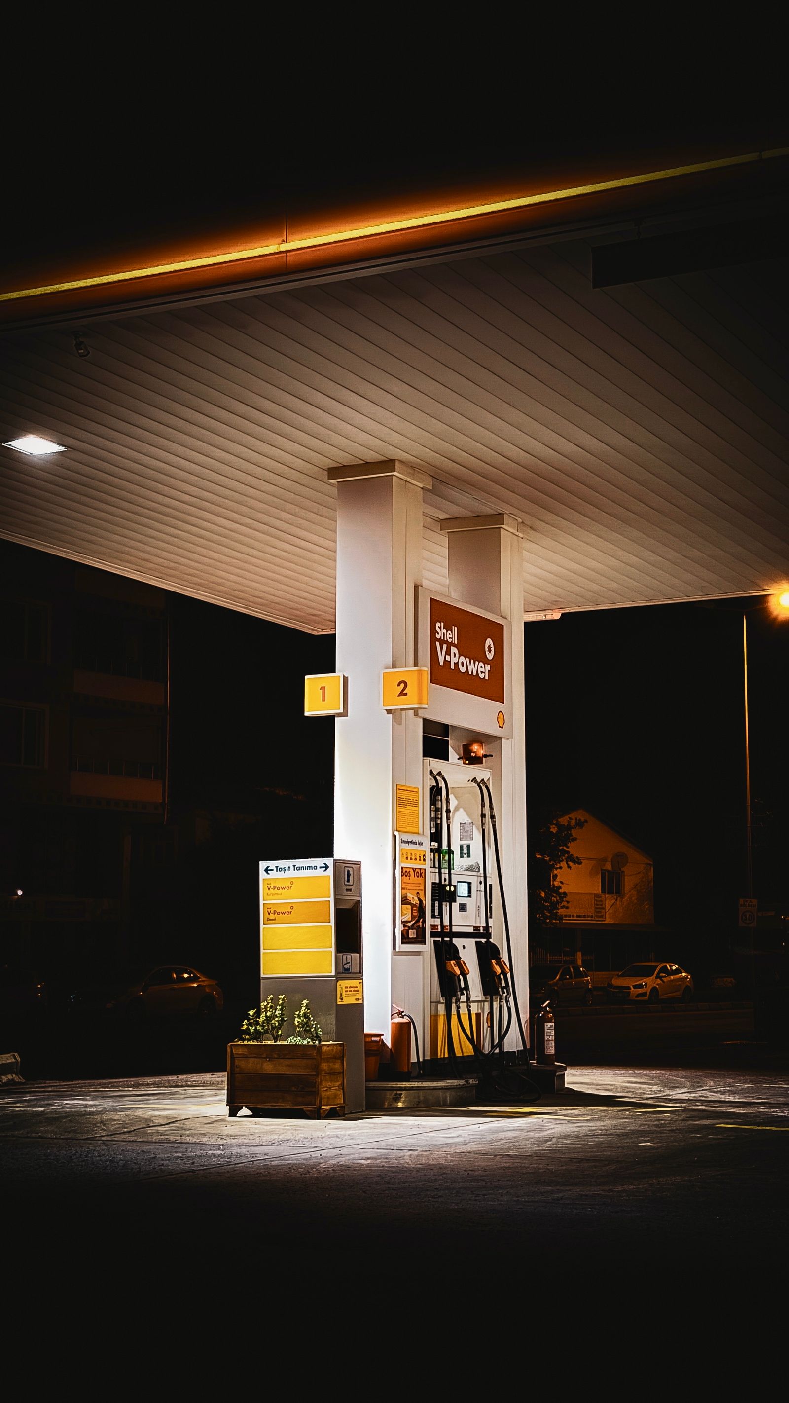 An illuminated fuel station canopy at night