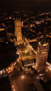 A stunning nighttime aerial view showcasing Ghent's historic architecture and city lights.