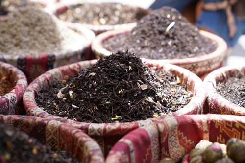 Free Vibrant spice market scene showcasing piles of diverse herbs and spices in traditional woven baskets. Stock Photo